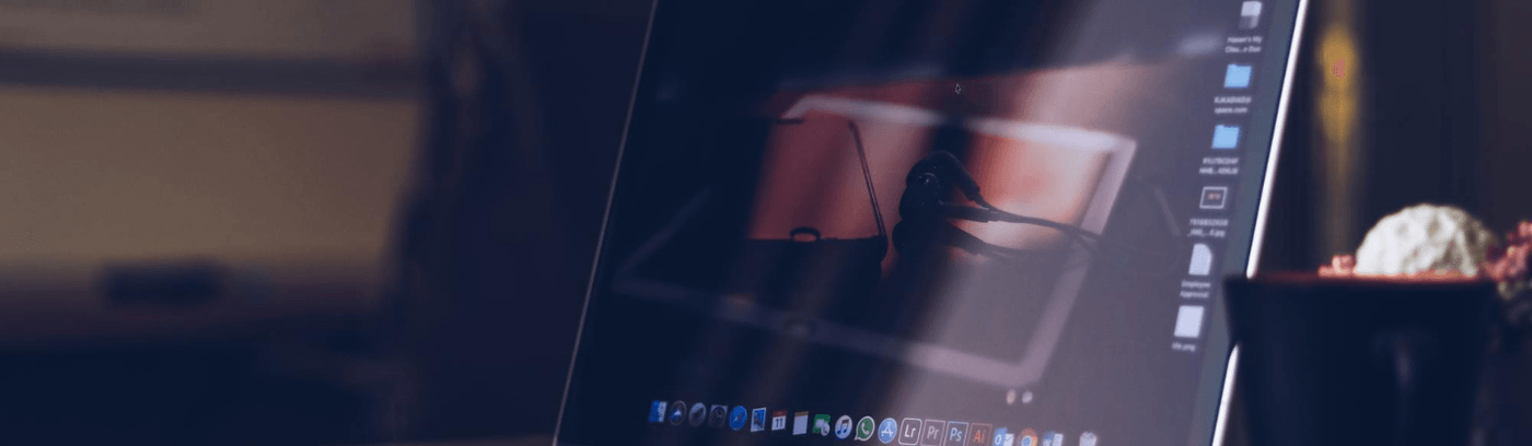A laptop placed on a desk next to a cup of coffee, symbolising a productive work environment.