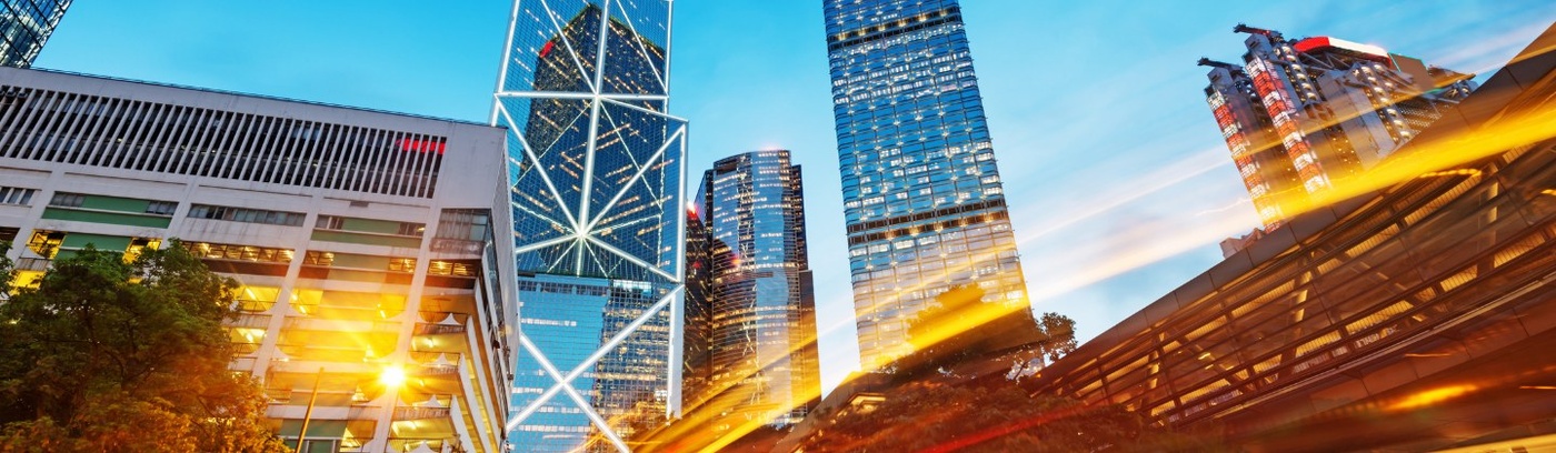 A vibrant urban scene showcasing skyscrapers and traffic lights against a clear sky.