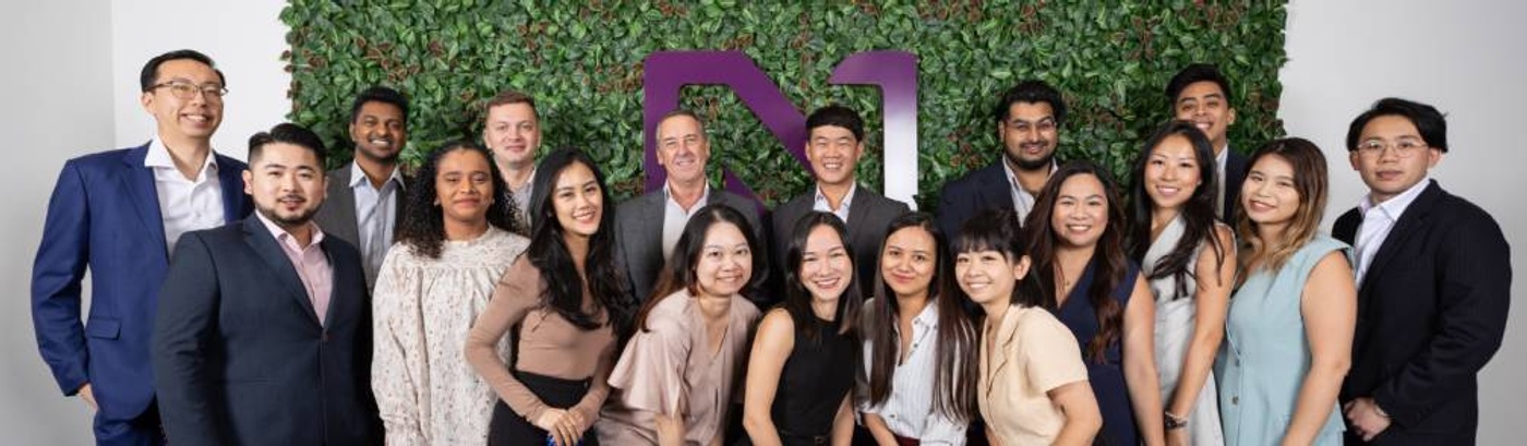 Team members of Nicoll Curtin's Singapore office gather for a photo, celebrating 10 years of collaboration and success.