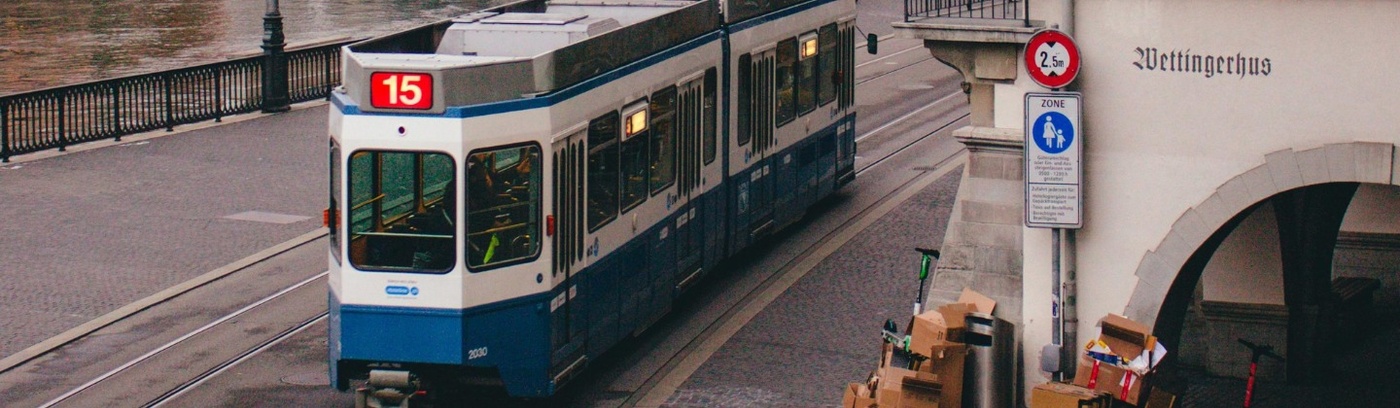A train traveling along a railway track, showcasing its sleek design and vibrant colors against a clear sky.