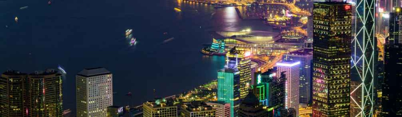  The Hong Kong skyline at night, featuring a dazzling array of lights from skyscrapers and a serene atmosphere over the harbor.