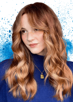Girl smiling with blue paint splash in background