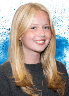 A headshot of a woman with blonde hair and a blue paint splash in the background