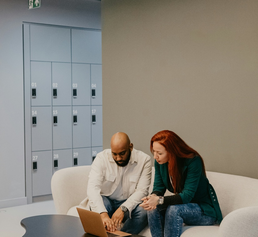 Two professionals reviewing work together on a laptop