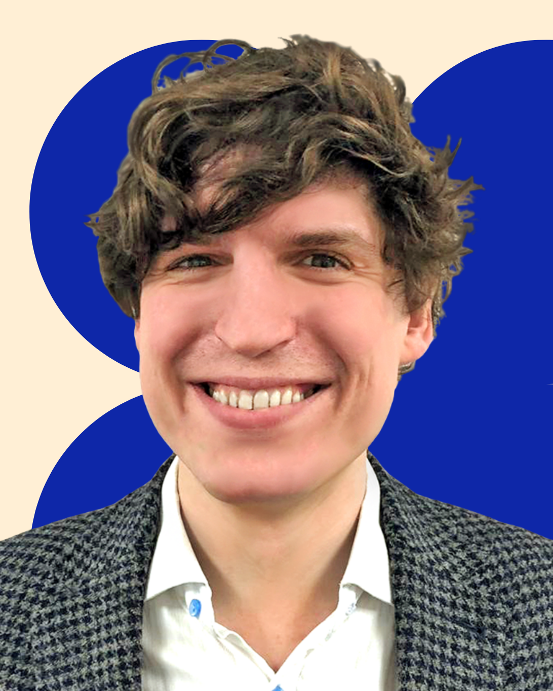Headshot of Josh Taylor smiling in a grey check blazer and white shirt.